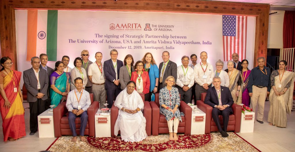 Amma, Dr. Liesl Folks, and all the representatives posing for a picture.