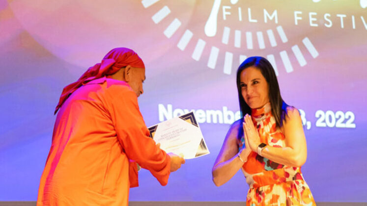 Swami Dayamritananda Puri accepts an award at the Illuminate Film Festival in Arizona, where the documentary also screened.