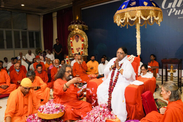 Amma's most senior disciple, Swami Amritaswarupananda Puri, performs Pada Puja to Amma.