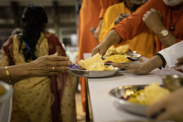 Amma distributed prasad in the form of a delicious meal including rice, curry, papadum, achar, payasam, and a chocolate biscuit.